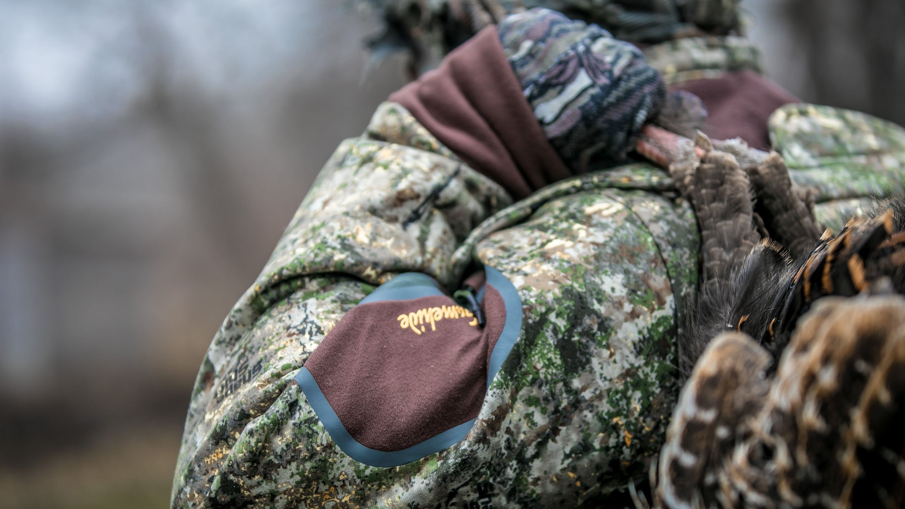 Close up shot of camo jacket turkey hunter