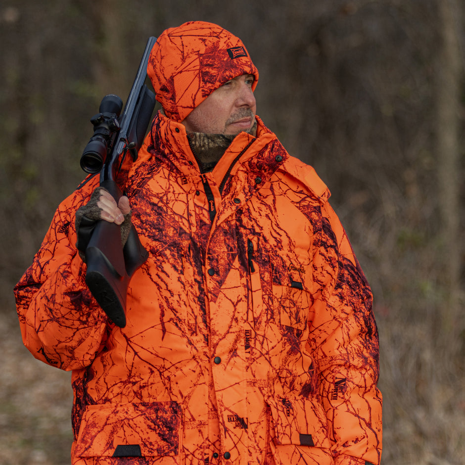 gamehide blaze orange camo hunter in field